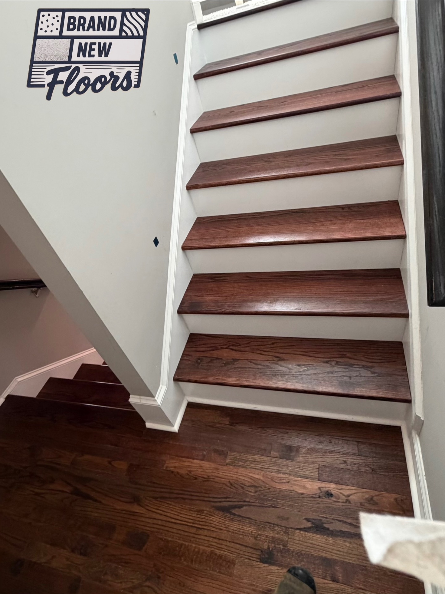 Dark wood stair treads and landing with white risers